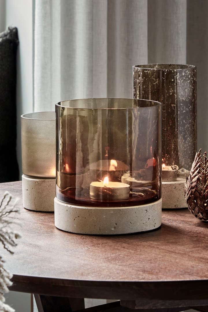 The material stone and the colour brown are among the interios design trends in autumn 2025. Here, the Rivo candle holder from House Doctor stands on a dining table.
