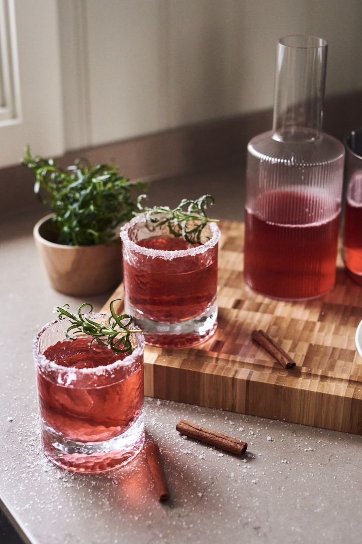 4 festive cocktail recipes for new year - Holmegaard Forma water glass next to Ferm Living Ripple carafe.