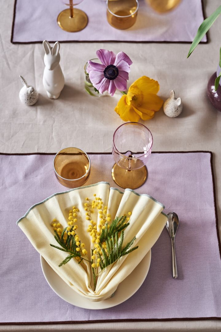 Your Easter table setting ideas should always include a napkin fold like the one you see here in tones of yellow. 