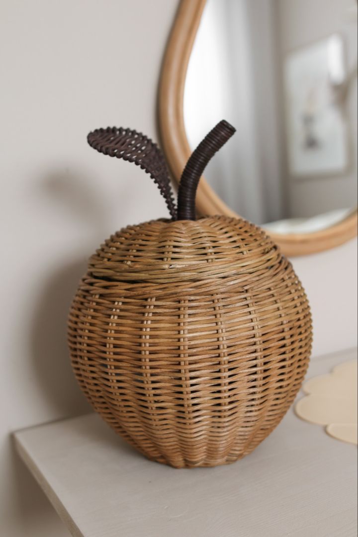 Include cute storage accessories in your children's room like this small apple wicker storage basket from ferm LIVING.