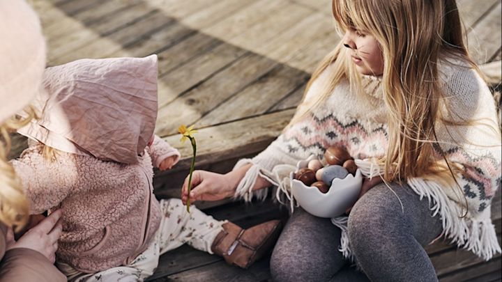 How to organise an egg hunt with clues this Easter  - Children dressed as Easter bunnies sit on the stairs and will share the Easter candy which was the prize in this year's big egg hunt.