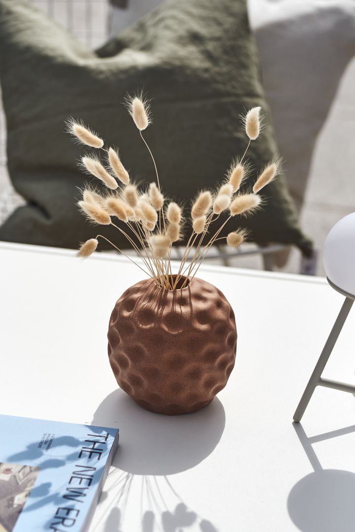 Rustic details add a tactile touch to your Mediterranean decor, like the Seedpod vase in walnut from Cooee Design. 