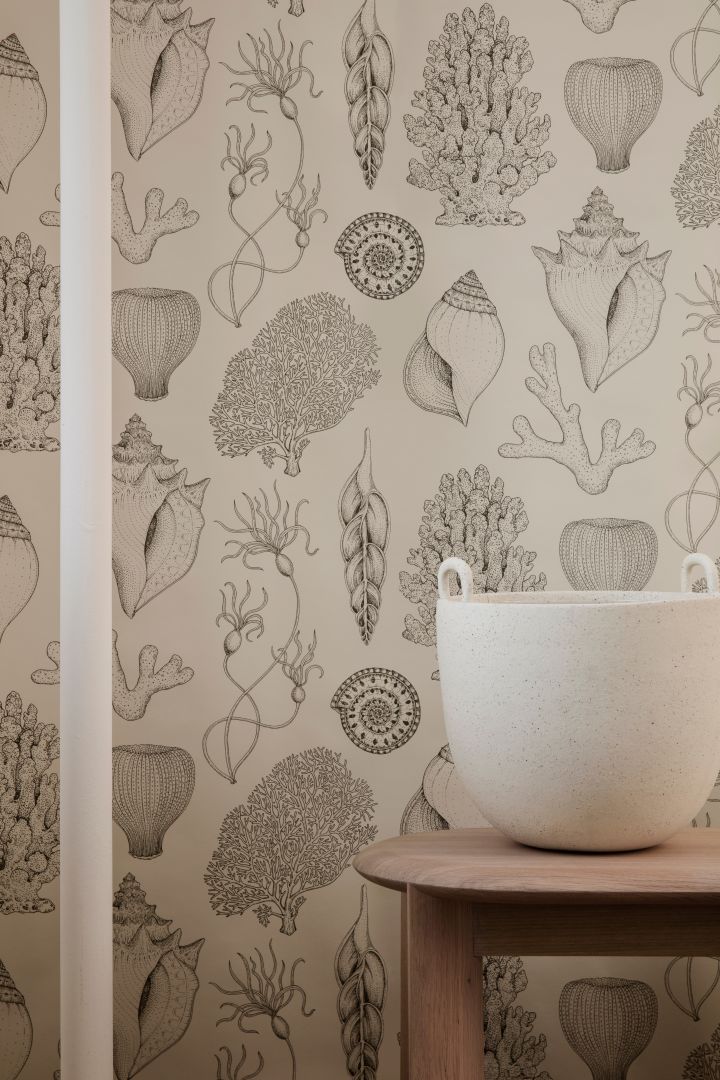 The wallpaper with snail pattern from Ferm Living shows how sea motifs will be big in interior design 2021.