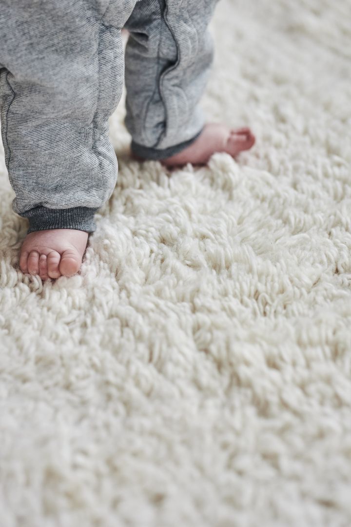 Create a cosy hygge living room with a cosy deep pile rug like this one from Scandi Living, seen here with little baby toes! 